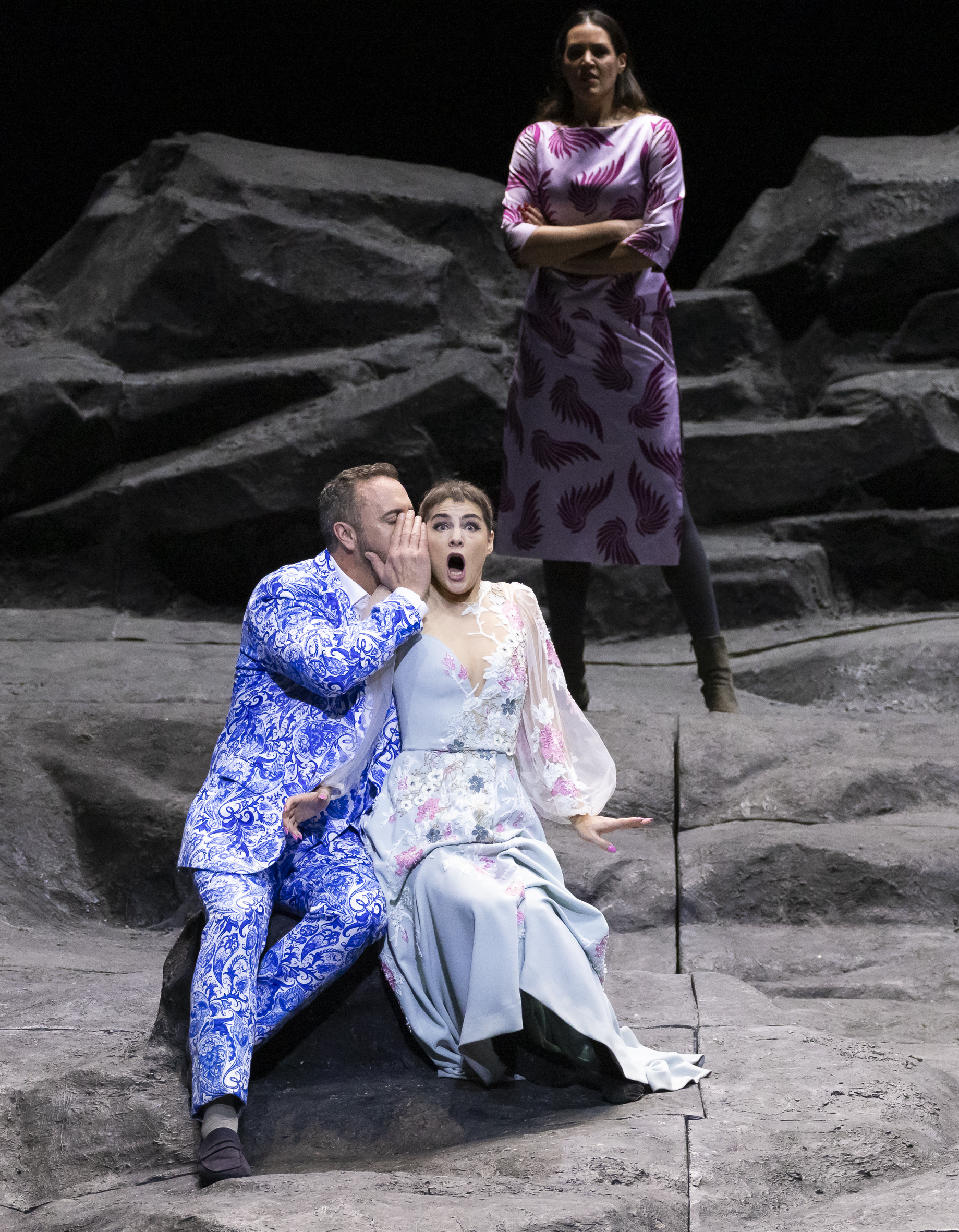 Christian Van Horn in a blue patterned suit on stage in Don Giovanni