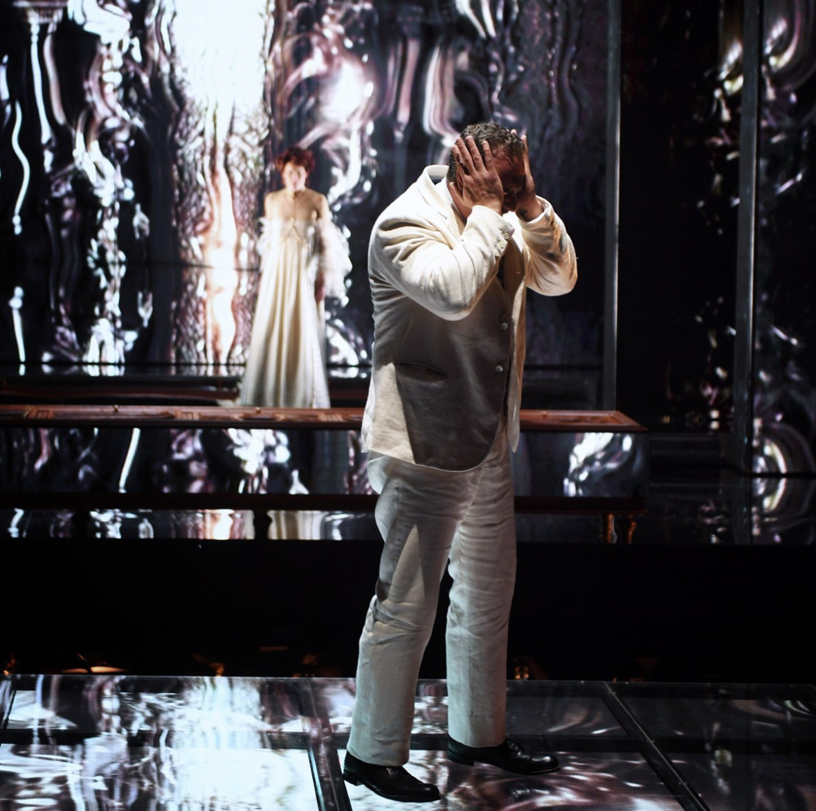 Christian Van Horn as Duke Bluebeard covers his face while Judith stands behind him in Des Moines Metro Opera’s Bluebeard’s Castle.