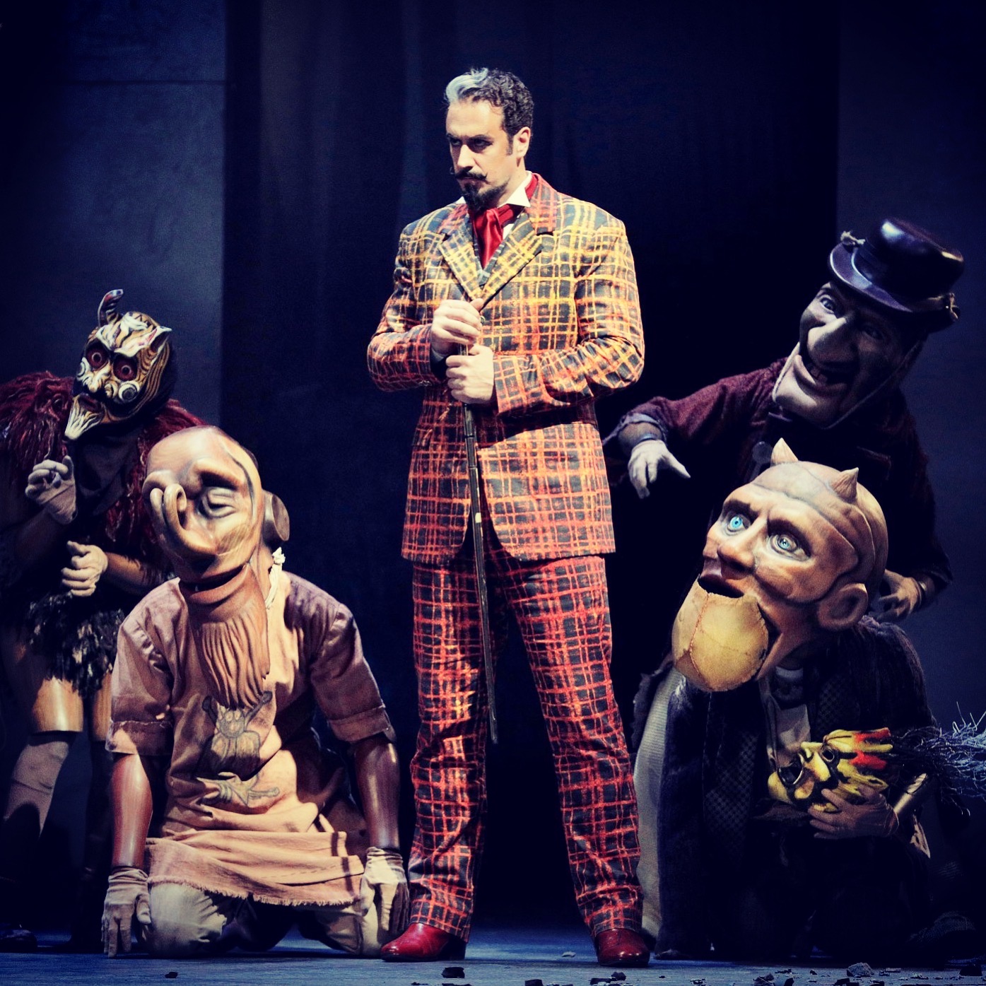 Christian Van Horn as Méphistophélès among masked figures in Lyric Opera of Chicago’s Faust