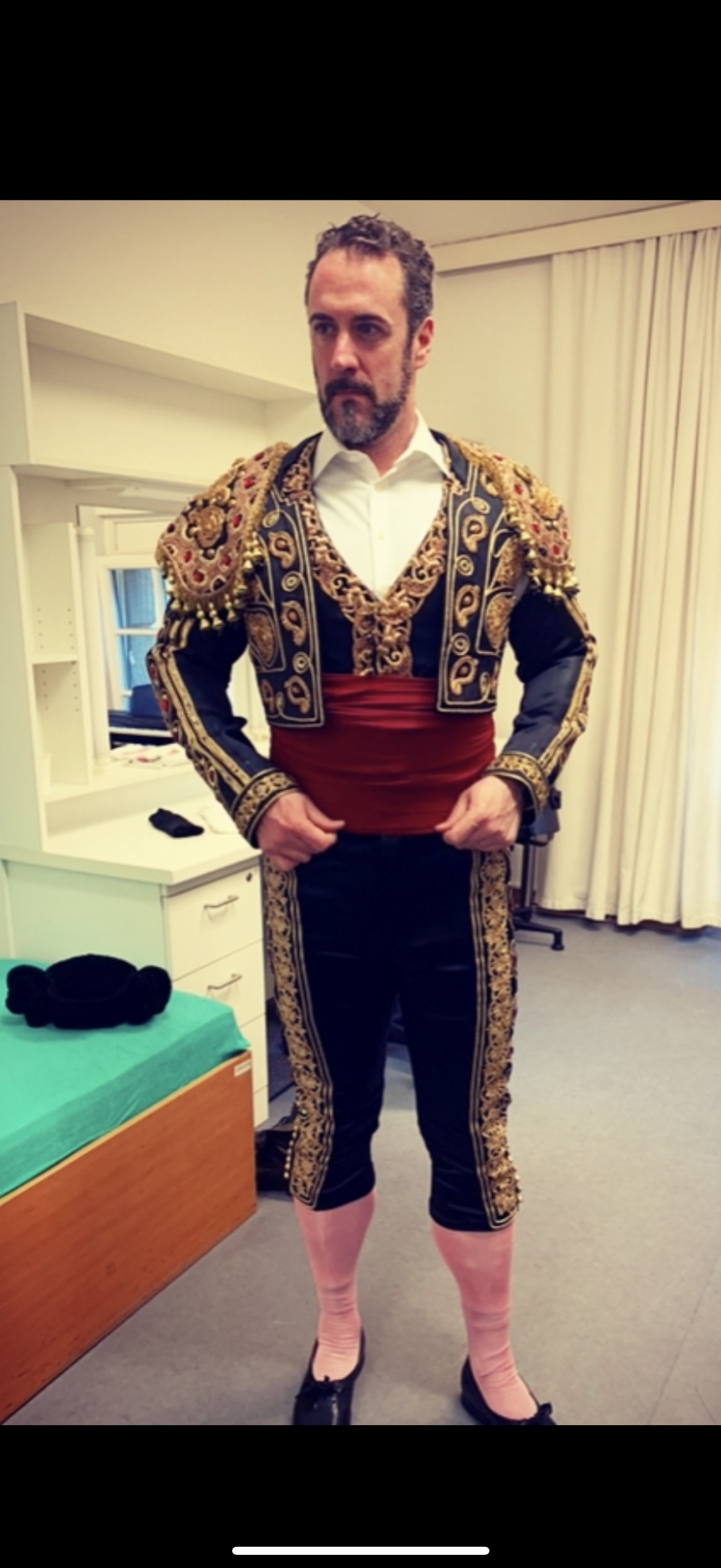 Christian Van Horn in ornate matador costume backstage.