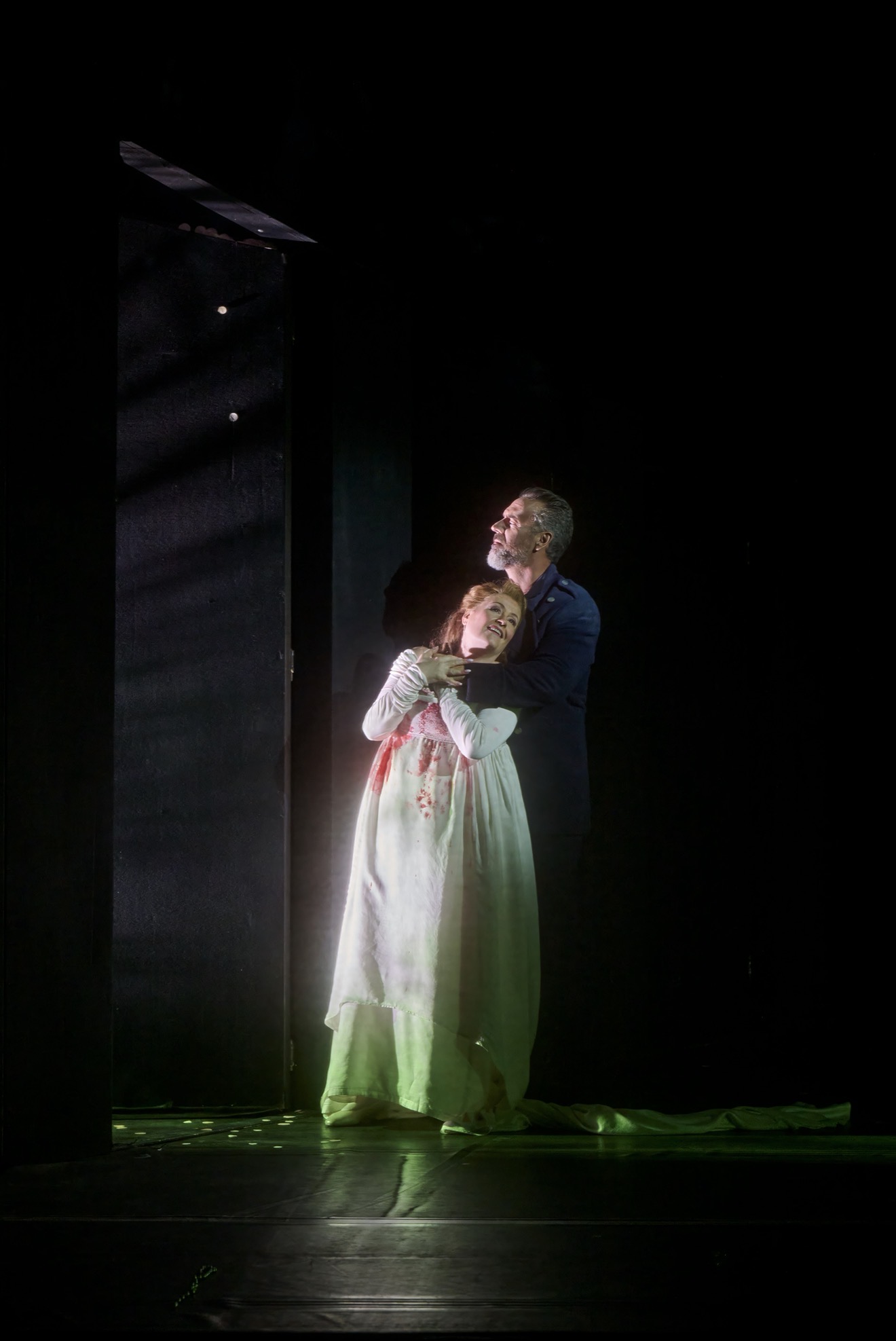 Christian Van Horn as Bluebeard stands behind Karen Cargill as Judith beside a dark door onstage.
