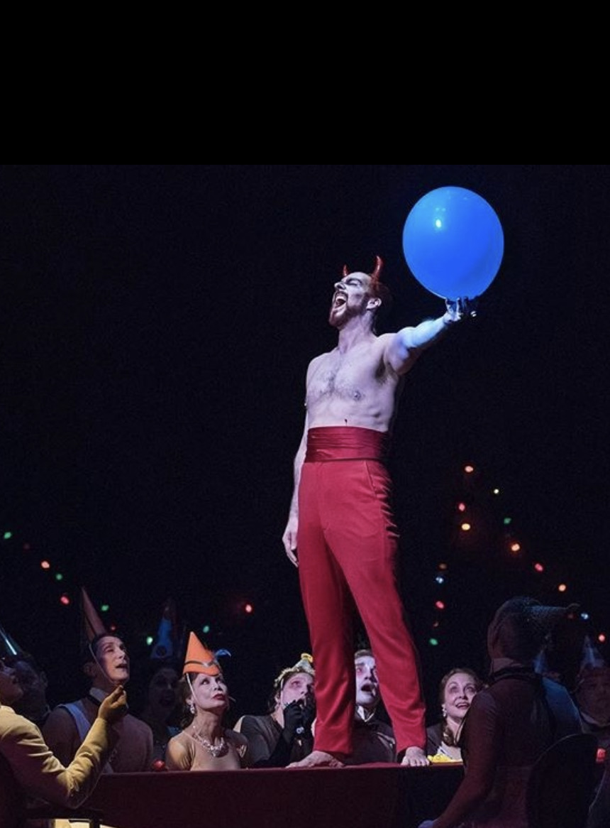 Christian Van Horn as Mefistofele holding a blue balloon at the Metropolitan Opera