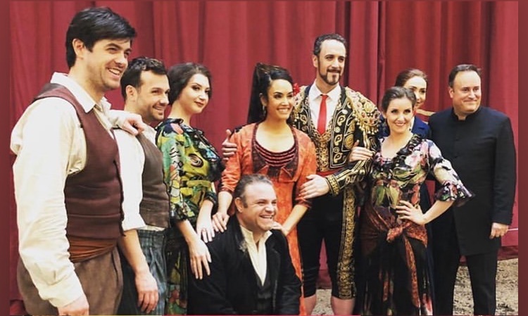 Christian Van Horn in Escamillo costume with a Carmen cast group.