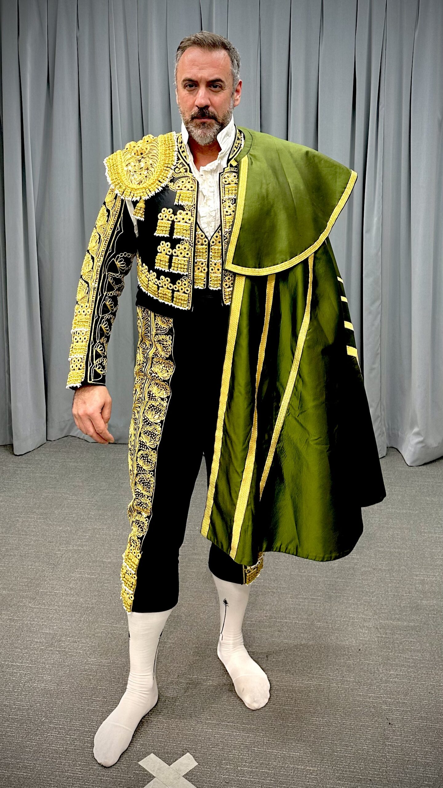 Christian Van Horn in an ornate Escamillo costume and green cape.