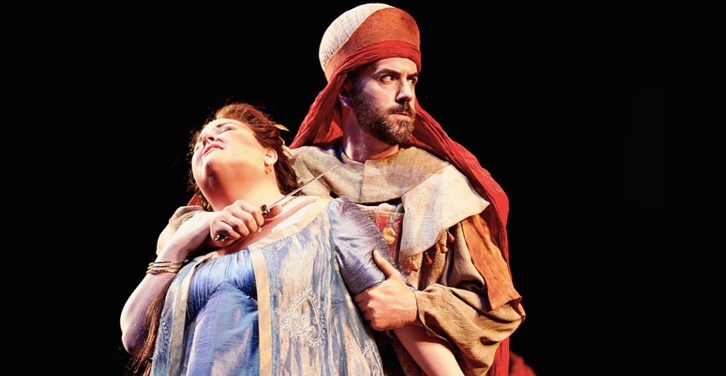Christian Van Horn as Zaccaria in a red head covering with a fellow performer onstage at Seattle Opera.