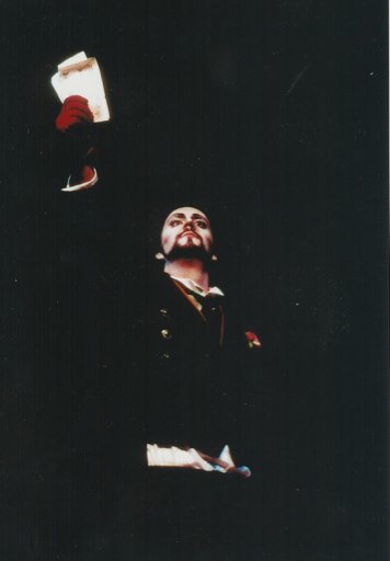 Young Christian Van Horn as Méphistophélès in Yale Opera’s Faust, raising a paper aloft